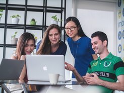 Four people watching on white Mac.
